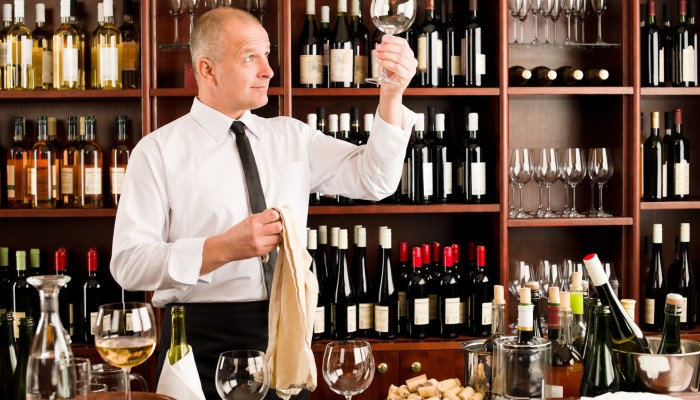 Wine bar waiter clean glass in restaurant